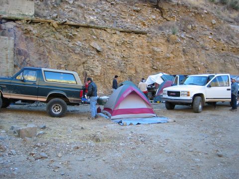 1994 Ford Bronco - Two trucks and tents set up at a campsite in a rocky, outdoor area.