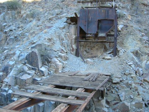 1994 Ford Bronco - This abandoned mine equipment sits on a rocky hillside, with a dilapidated wooden bridge in the foreground.