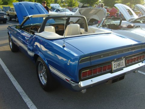 2007 Ford Mustang - A blue 1969 Shelby GT500 convertible is parked at an outdoor car show with its hood up.
