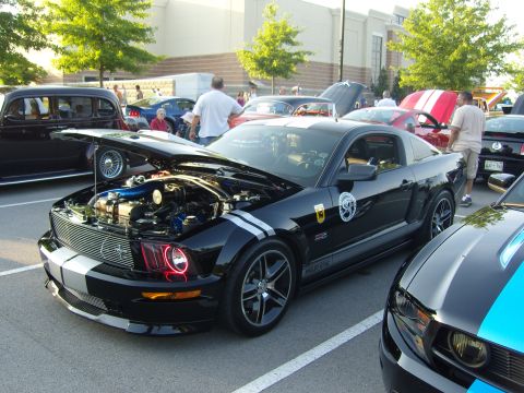 2007 Ford Mustang - Black 2007 Ford Mustang at a car show, hood open to display the engine bay.