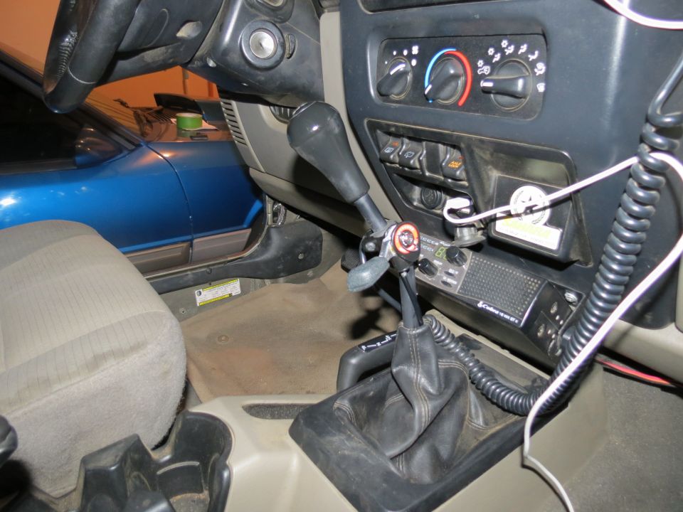 Interior view of 2005 Jeep Wrangler with hand throttle and CB radio