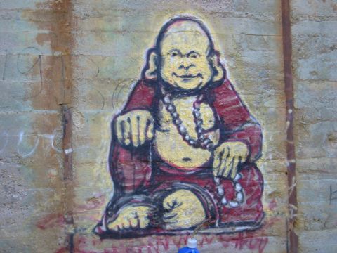 1994 Ford Bronco - Graffiti art depicts Buddha seated on a concrete wall, with a watermark for Supermotors.net visible at the bottom right.