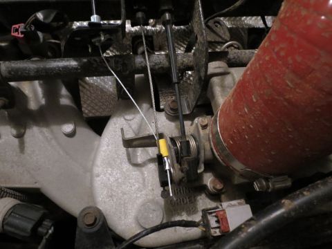 2005 Jeep Wrangler - This photo shows the throttle body and associated cables within an engine compartment.