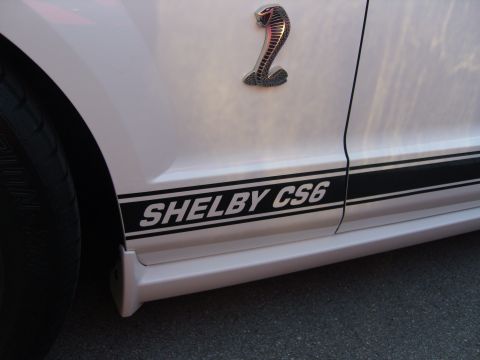 2007 Ford Mustang - Close-up of a Shelby CS6 side stripe and emblem on a white vehicle.