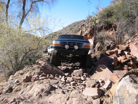1994 Ford Bronco - This Ford Bronco navigates a rocky off-road trail with another vehicle following behind.
