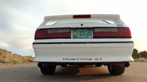 1989 Ford Mustang - Rear view of a white 1989 Ford Mustang GT, its distinctive taillights and GT badging.