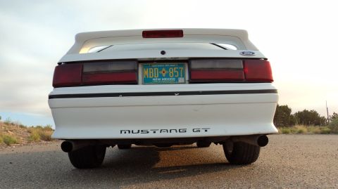 1989 Ford Mustang - Rear view of a white 1989 Ford Mustang GT parked outdoors.