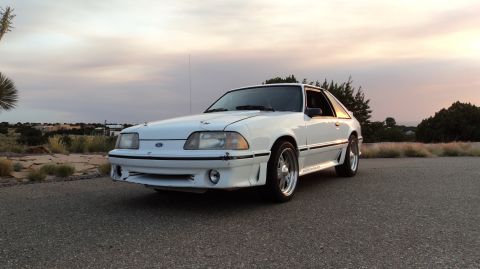 1989 Ford Mustang - This 1989 Ford Mustang coupe features a distinctive body kit and is captured in a three-quarter front view.