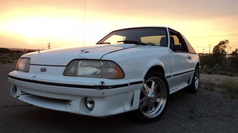 1989 Ford Mustang - White 1989 Ford Mustang GT coupe with aftermarket wheels at sunset.