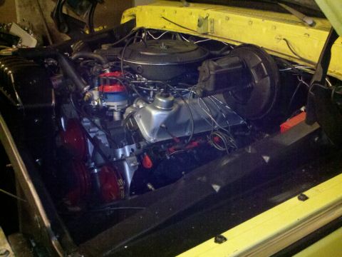 1978 Ford Bronco - Engine bay of a yellow vehicle, showing the V8 engine components and wiring.