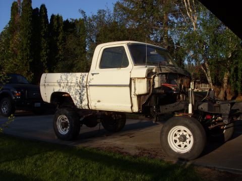 1967 Ford F-250 - White 1967 Ford F-250 pickup truck project with front end removed, parked next to a black SUV.