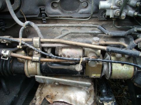 1989 Ford Probe - Engine compartment detail with fuel lines and starter motor visible.
