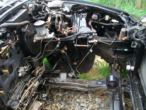 1989 Ford Probe - The engine bay of a car is shown with many components removed, revealing the chassis and brake system.