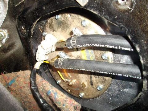 1989 Ford Probe - Close-up of a vehicle's fuel pump assembly, showing hoses and wiring.
