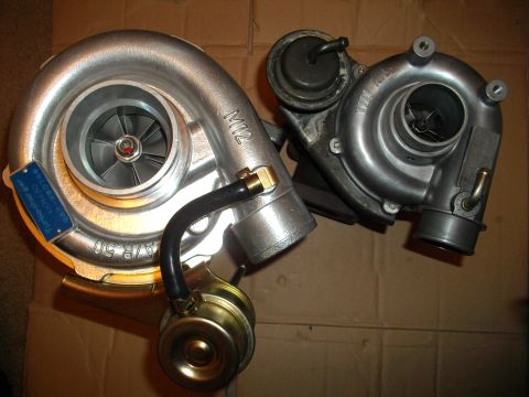 1989 Ford Probe - Comparison of two turbochargers, one with a blue identification tag and A/R.50 specification.