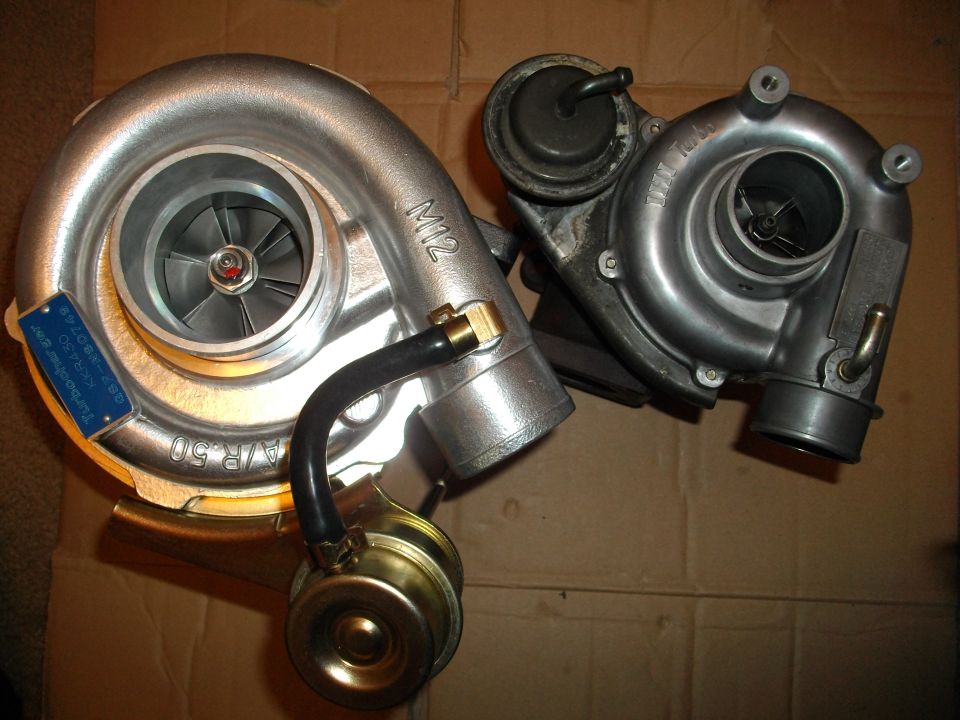 Two turbochargers, one larger with blue tag and A/R.50 marking, the other smaller and darker