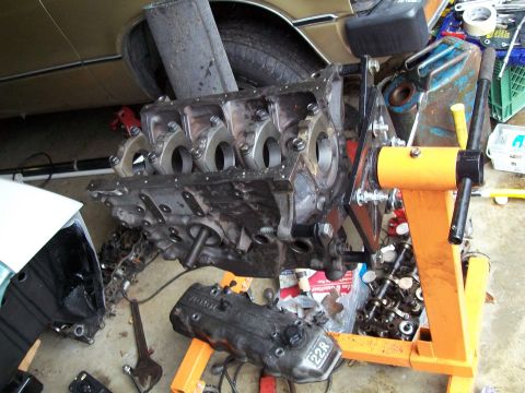 1989 Ford Probe - Engine block and cylinder head on an engine stand, likely undergoing repair or rebuilding.