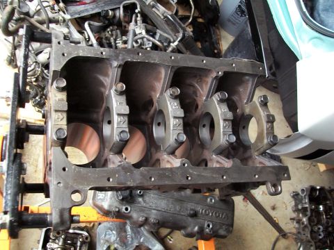1989 Ford Probe - A disassembled engine block is shown, with a valve cover bearing the 'TOYOTA' nameplate.