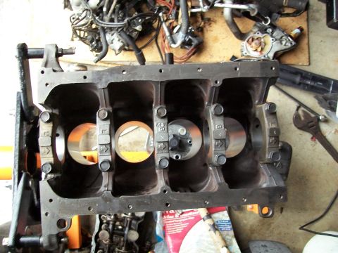 1989 Ford Probe - Engine block with visible cylinder bores and connecting rod caps, part of a larger engine assembly.