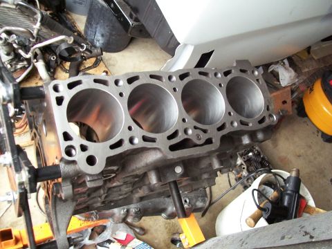 1989 Ford Probe - Engine block with four cylinders, likely undergoing repair or rebuild.