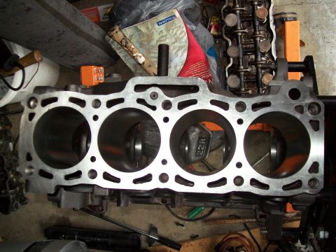1989 Ford Probe - Close-up of an engine block showing the cylinders and pistons, with other engine components in the background.