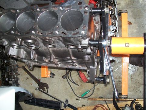 1989 Ford Probe - Engine block on a stand, surrounded by tools and parts.
