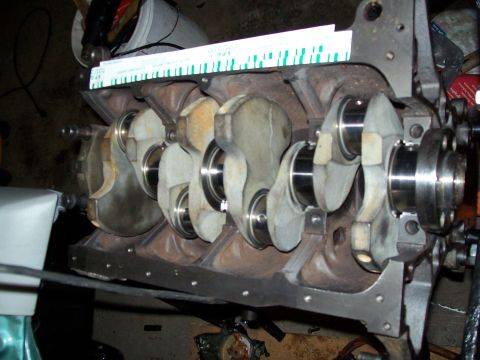 1989 Ford Probe - Close-up view of an engine's crankshaft and bearing assembly, with a ruler placed on top for measurement.