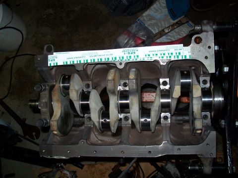1989 Ford Probe - Engine block with crankshaft and plastigage tool for measuring clearance.