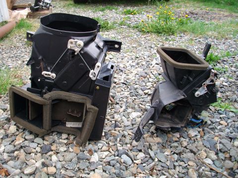 1989 Ford Probe - Disassembled car interior climate control parts lie on a gravel surface.