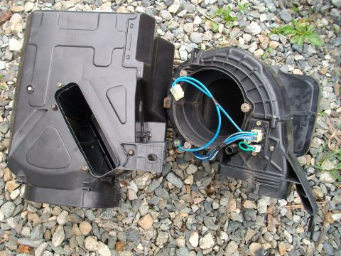 1989 Ford Probe - Disassembled blower motor housing and fan assembly, showing the internal components and wiring.