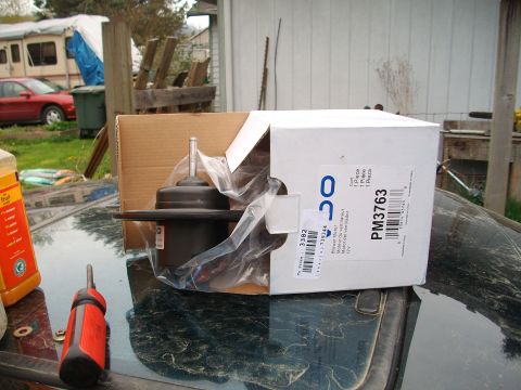 1989 Ford Probe - New blower motor part in its box, along with a screwdriver and a bottle of fluid.