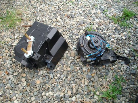 1989 Ford Probe - The blower motor and evaporator core are shown disassembled on a gravel surface.