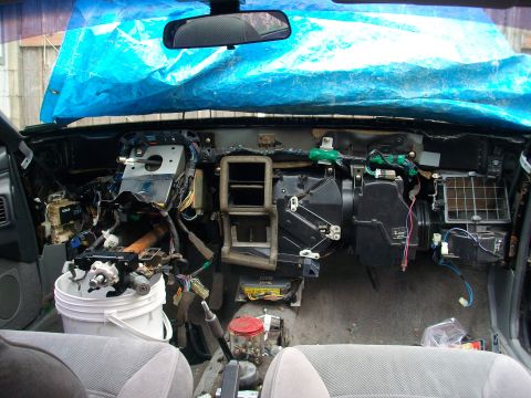 1989 Ford Probe - The interior of a car is disassembled, revealing the dashboard's internal components and wiring.