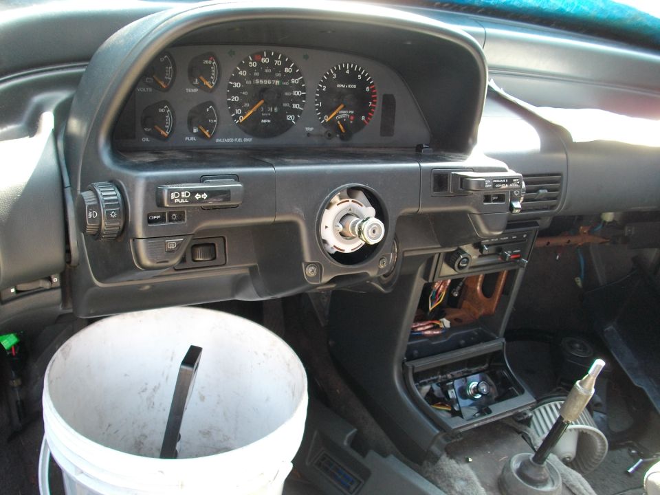1989 Ford Probe interior showing dashboard with steering column removed, gauges, and center console