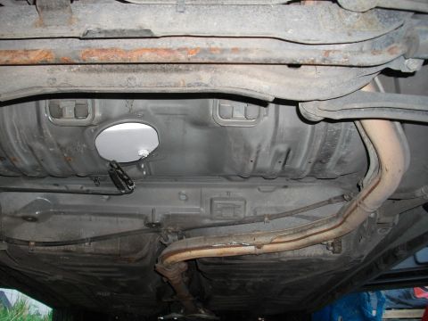 1989 Ford Probe - Underside view of a car's fuel tank and exhaust system.