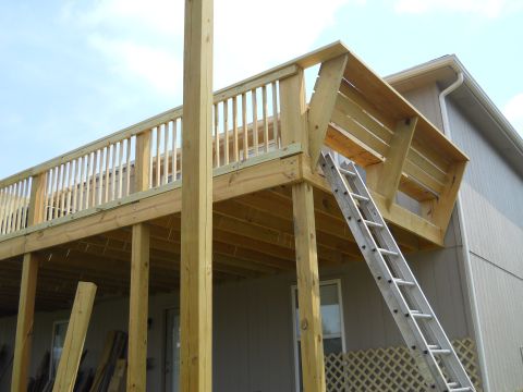 1976 Ford Bronco - A new wooden deck is being built, with a ladder providing access to the upper level.