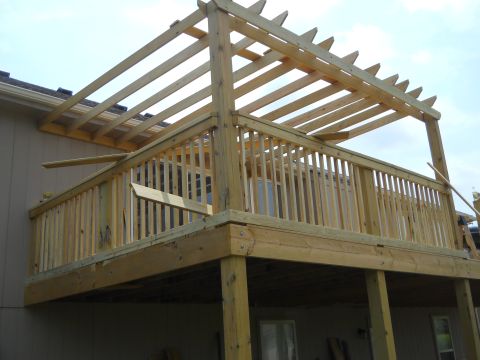 1976 Ford Bronco - A wooden deck and pergola structure is shown under construction, with visible lumber and framing.