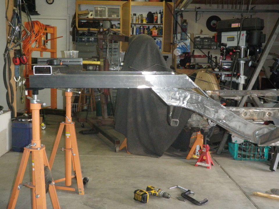 Vehicle frame on jack stands, showing metal fabrication and welding