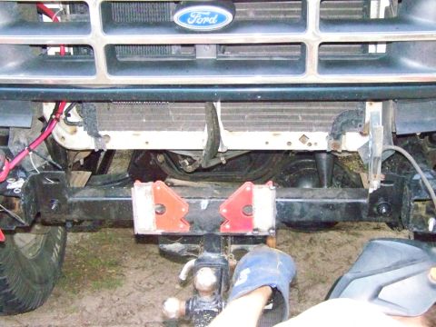 1985 Ford Bronco - Front view of a Ford truck, likely from the early 1990s, with a tow hitch and welding gear.