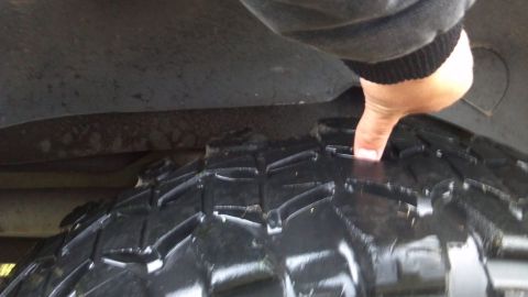 1995 Jeep Cherokee - Checking tire tread depth on an off-road tire.