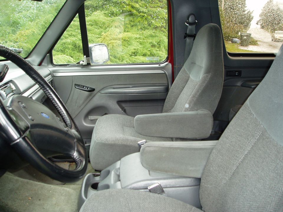 1993 Ford Bronco interior with grey cloth seats and armrests