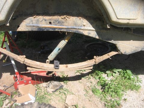 1987 Jeep Comanche - Vehicle's rear suspension components, including leaf springs and a shock absorber, are visible.