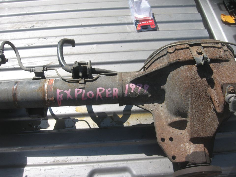 Rusty rear axle assembly with pink marker text 'EXPLORER 1978' on a metal surface