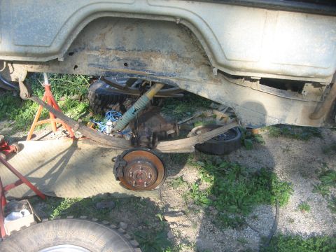 1987 Jeep Comanche - The rear axle and suspension components are exposed and appear to be undergoing maintenance or modification.