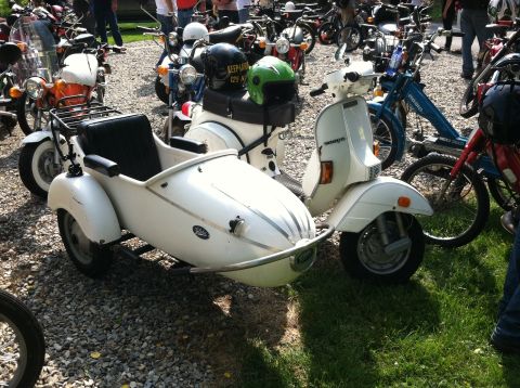 1981 Garelli Rally Sport - A white scooter with a sidecar is parked among other motorcycles.