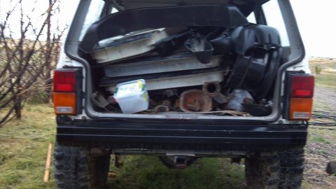 1995 Jeep Cherokee - This 1995 Jeep Cherokee is seen from the rear, its cargo area filled with various automotive parts.