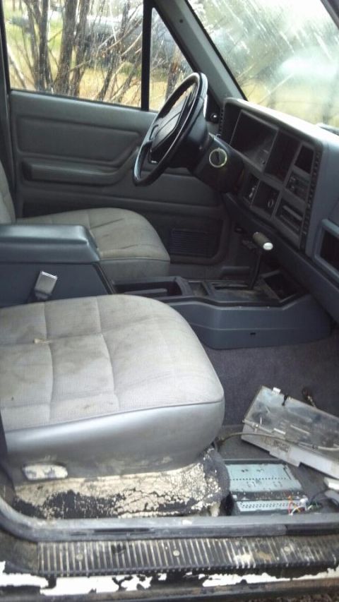 1995 Jeep Cherokee - Interior view of a 1995 Jeep Cherokee, including seats, dashboard, and steering wheel.
