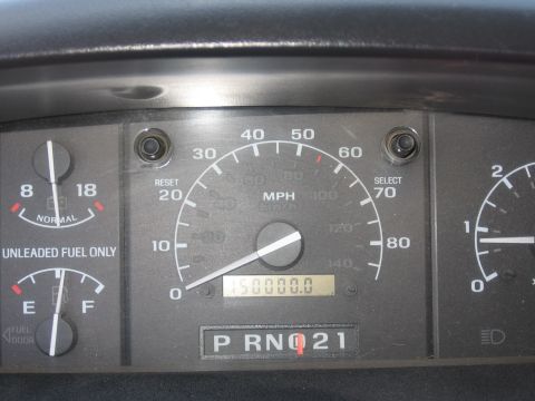 1995 Ford Bronco - Interior view of a vehicle's dashboard, showing the speedometer, fuel gauge, and odometer displaying 150,000 miles.
