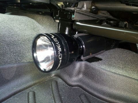 2011 Ford Ranger - A Maglite flashlight is mounted beneath a vehicle's seat, attached to the seat's support structure.