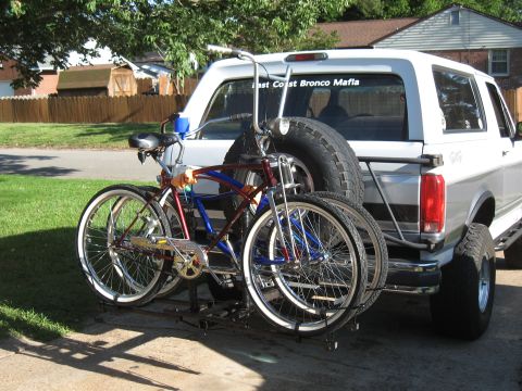1994 Ford Bronco - A white 1994 Ford Bronco is equipped with a rack carrying two bicycles, with a sticker on the rear window reading "East Coast Bronco Mafia".
